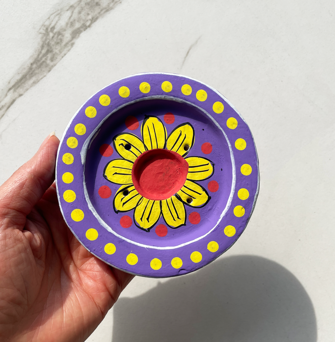 4 inch round hand painted terracotta purple incense burner with yellow flower in center and red and yellow dot design for incense cones and sticks bliss shop chicago