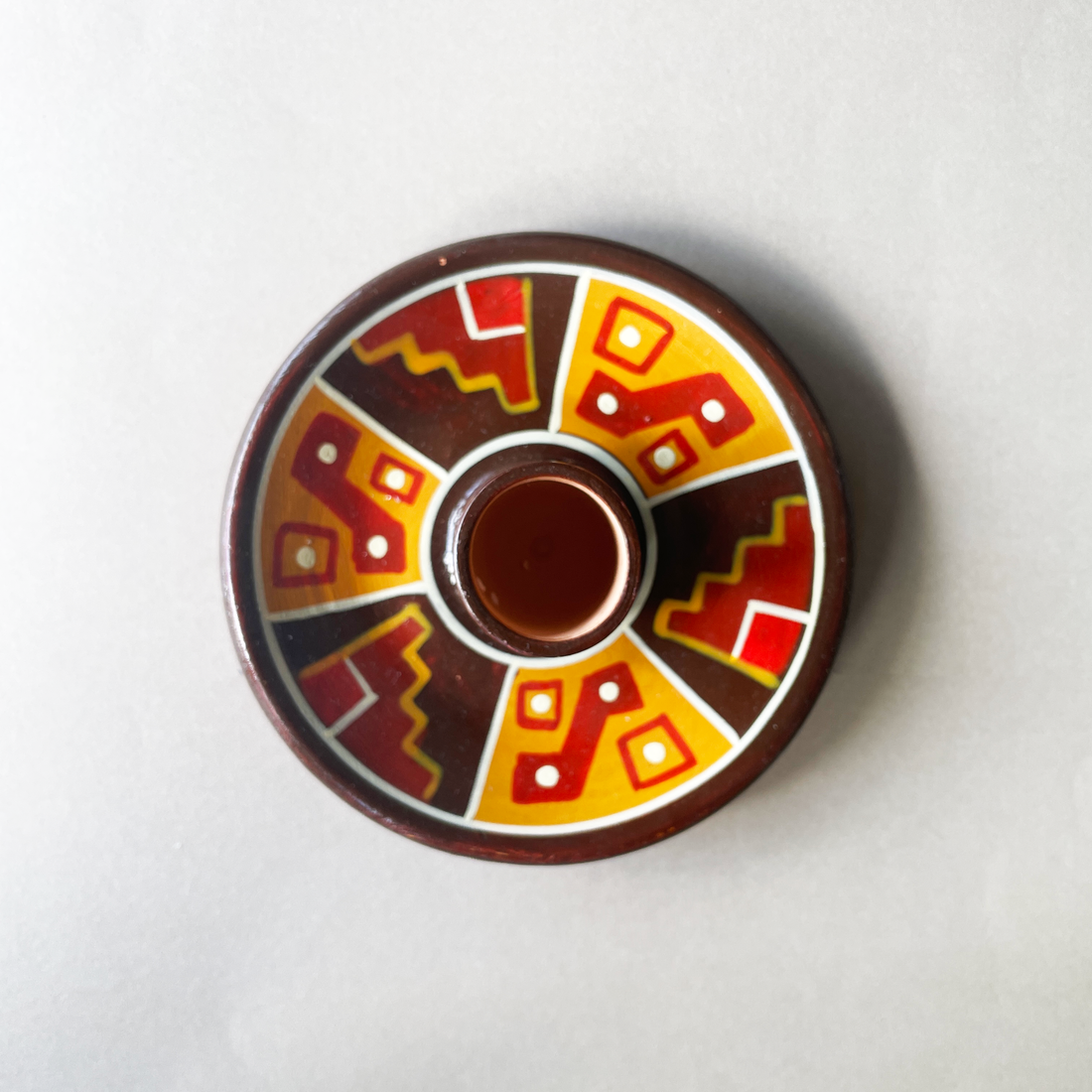 4 inch ceramic dish for palo santo sticks with peruvian geometric design in red orange  and brown bliss shop chicago