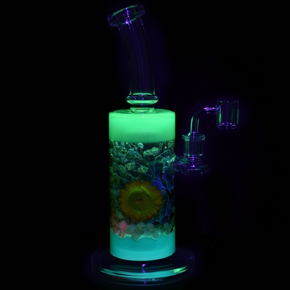 11 inch tall boro dab rig with glow in the dark green color and dried flowers encased in glass bliss shop chicago