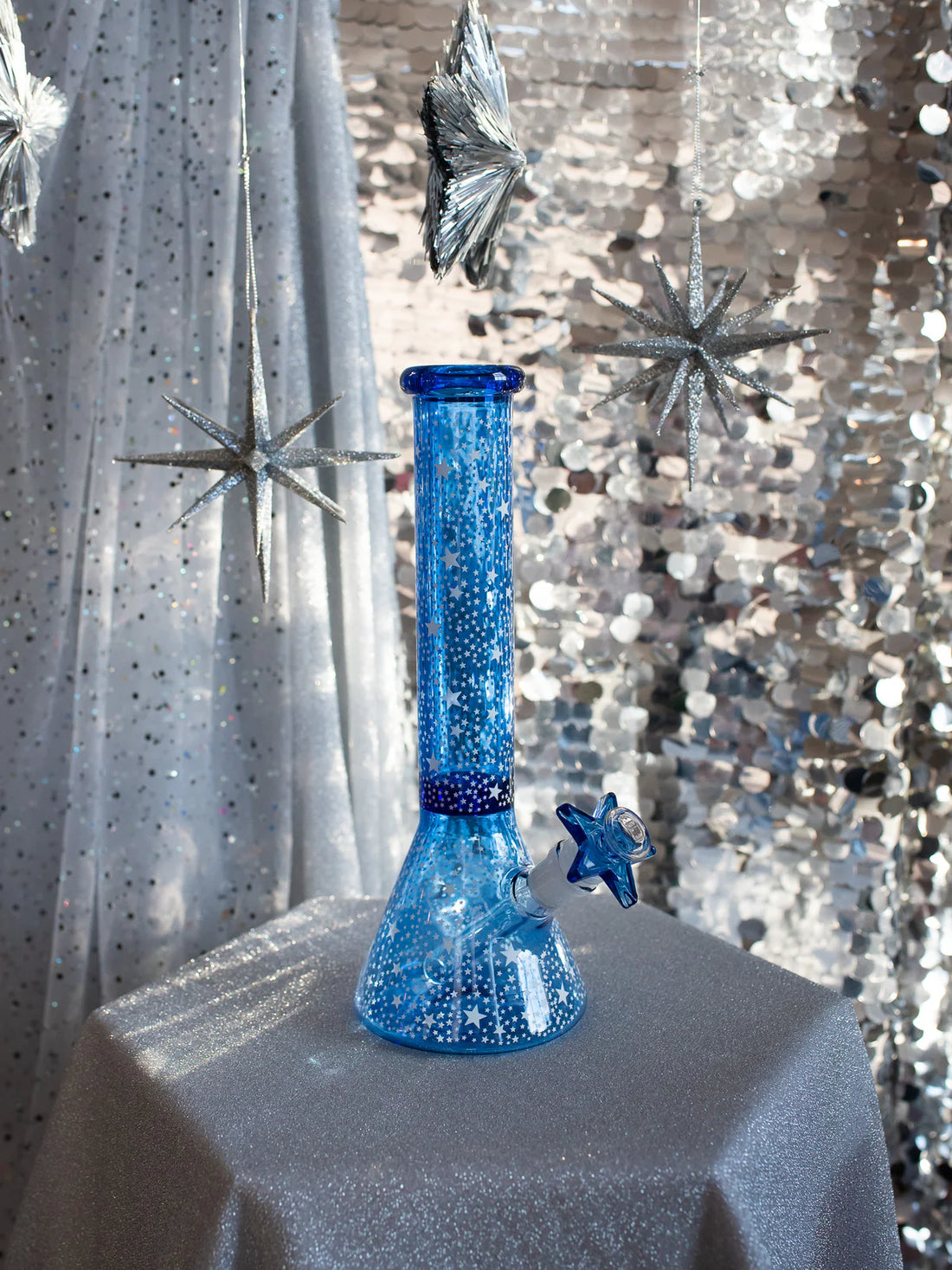 12 inch blue beaker style bong with small glow in the dark star designs all over bliss shop chicago