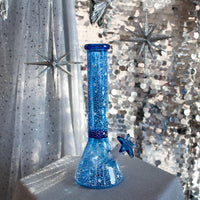 12 inch blue beaker style bong with small glow in the dark star designs all over bliss shop chicago