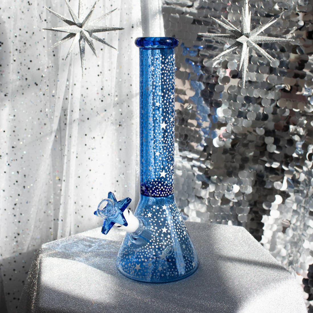 12 inch blue beaker style bong with small glow in the dark star designs all over bliss shop chicago