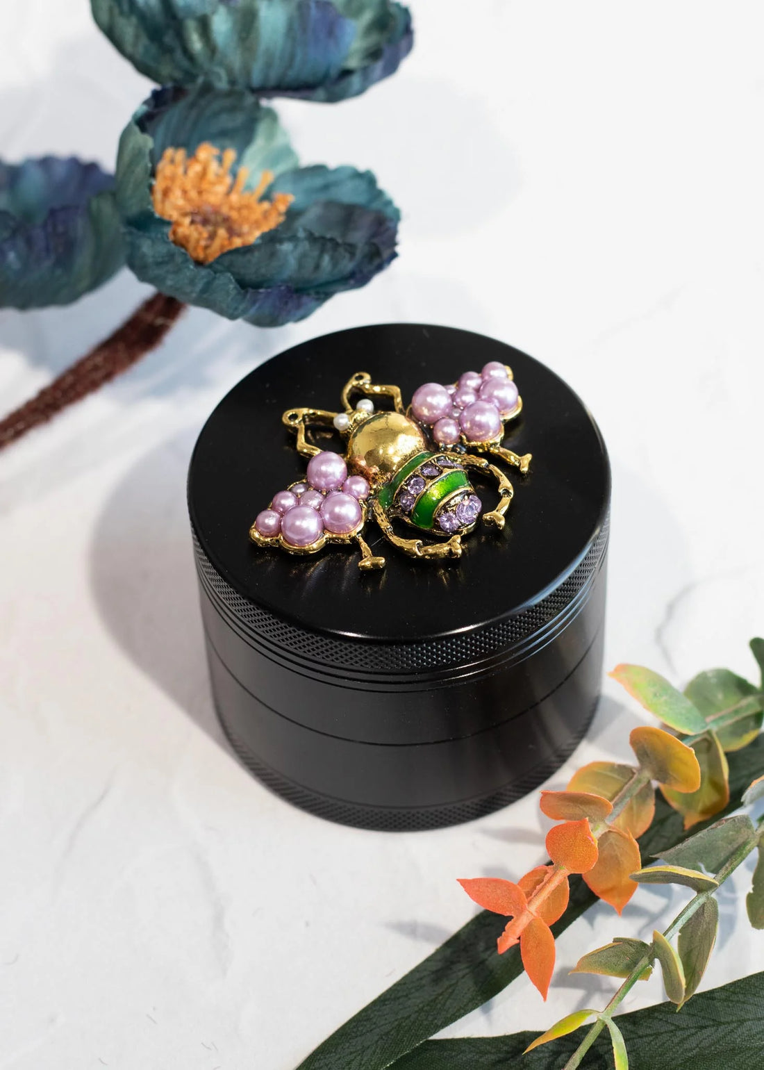 canna style 2.5 inch diameter black aluminum 4 piece grinder with  beetle encrusted in lavender gems & pearls on top lid bliss shop chicago