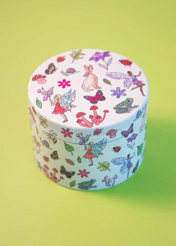 canna style 2.5 inch silver aluminum 4 piece grinder with off white background and cottage core design items like fairy, mushrooms, frogs, flowers, bunny bliss shop chicago