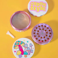canna style 2.5 inch diameter 4 piece pink aluminum grinder with bright and colorful mushroom and star designs bliss shop chicago