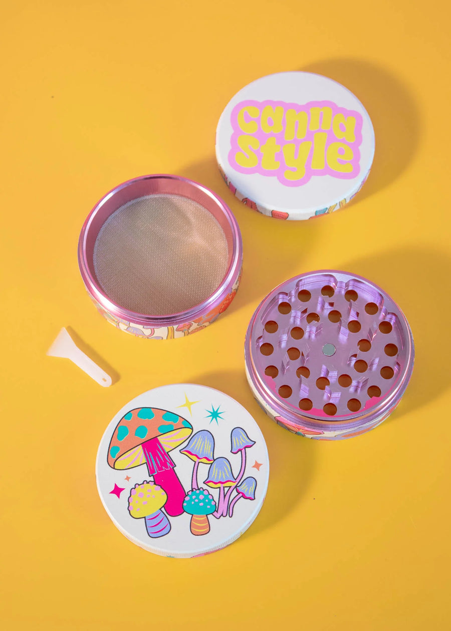 canna style 2.5 inch diameter 4 piece pink aluminum grinder with bright and colorful mushroom and star designs bliss shop chicago