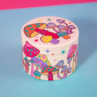 canna style 2.5 inch diameter 4 piece pink aluminum grinder with bright and colorful mushroom and star designs bliss shop chicago