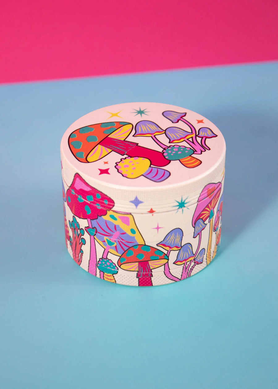 canna style 2.5 inch diameter 4 piece pink aluminum grinder with bright and colorful mushroom and star designs bliss shop chicago