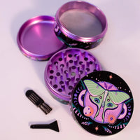 2.5 inch diameter purple aluminum 4 piece grinder with black background and green moth with celestial and floral design bliss shop chicago