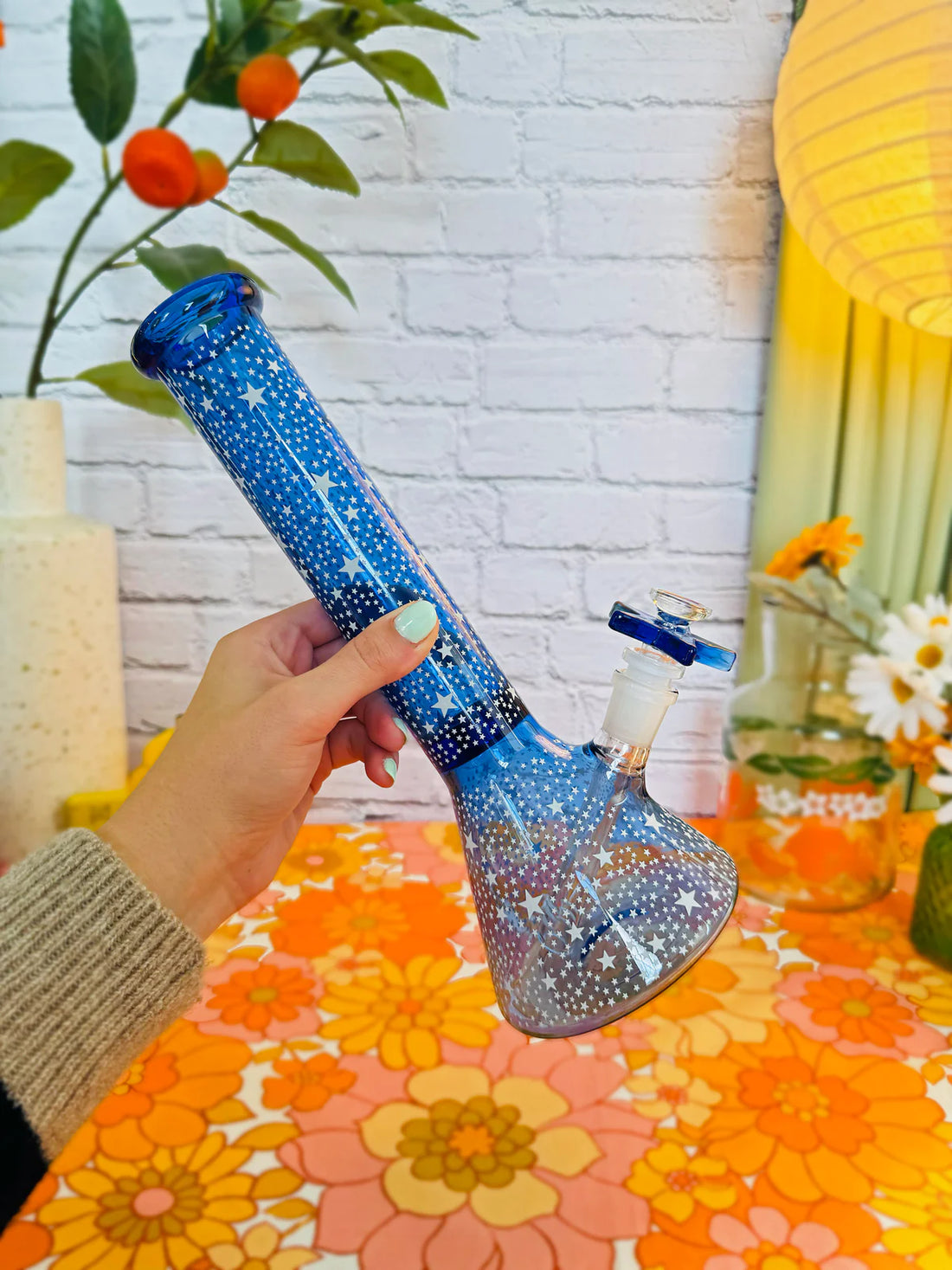 12 inch blue beaker style bong with small glow in the dark star designs all over bliss shop chicago