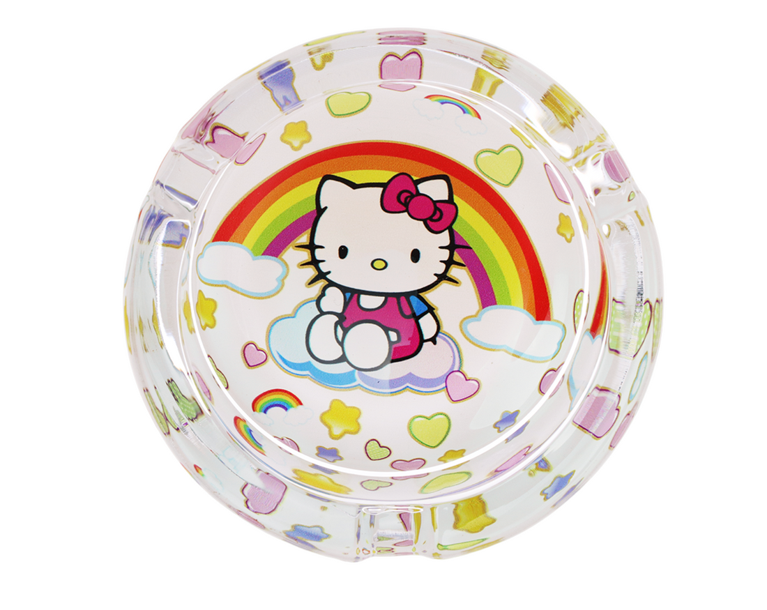 3.3" glass ashtray designed with hello kitty sitting on a cloud with a large rainbow, hearts and stars in the background bliss shop chicago