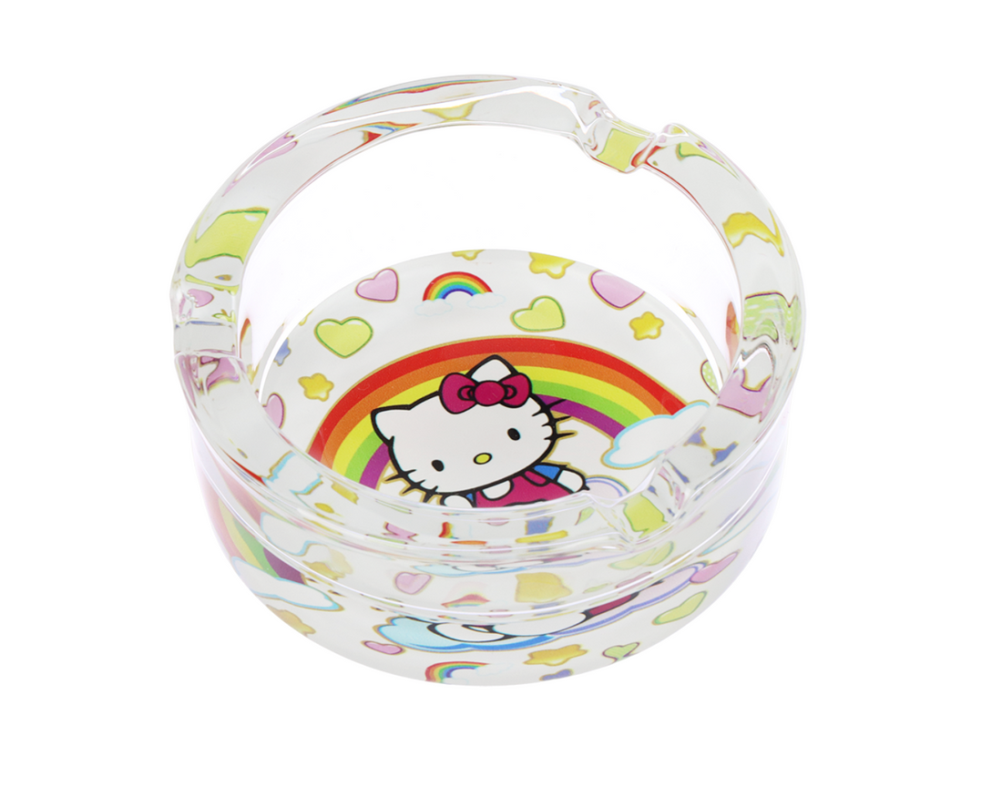3.3" glass ashtray designed with hello kitty sitting on a cloud with a large rainbow, hearts and stars in the background bliss shop chicago