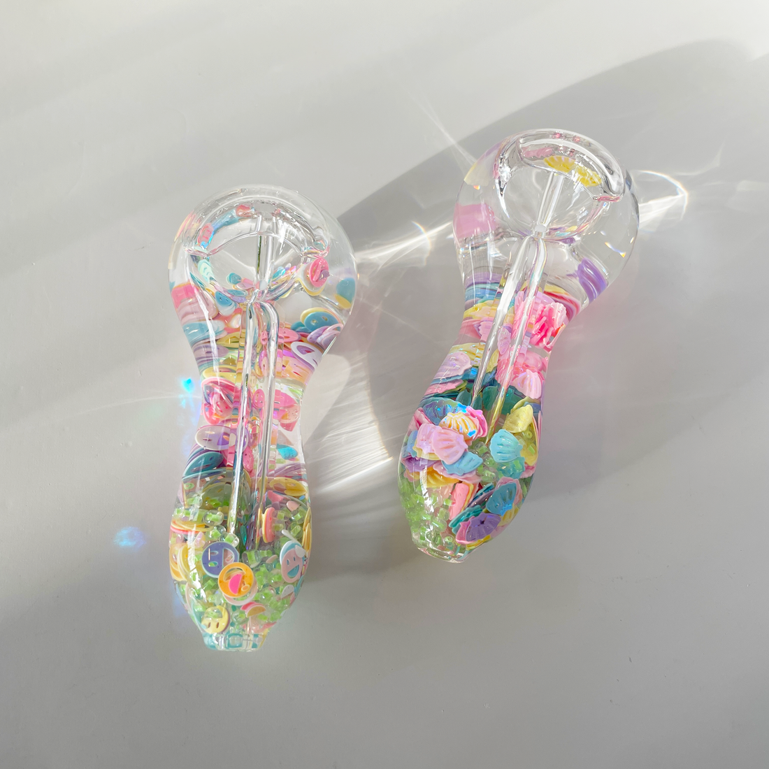 4 inch freezable glow in the dark hand pipe filled with colorful seashells and beads bliss shop chicago