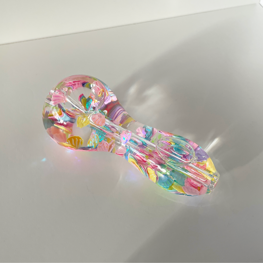 4 inch freezable glow in the dark hand pipe filled with colorful seashells and beads bliss shop chicago