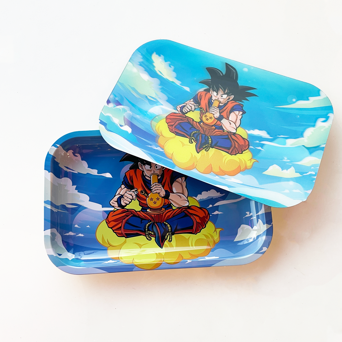10 by 7 inch metal rolling tray with magnetic lid of hologram image of dragon ball z goku on a cloud smoking a bong bliss shop chicago
