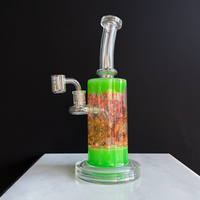 11 inch tall boro dab rig with glow in the dark green color and dried flowers encased in glass bliss shop chicago