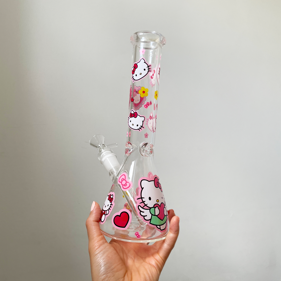 10 inch beaker bong with girly decals of hello kitty and red hearts and pink bows and flowers bliss shop chicago