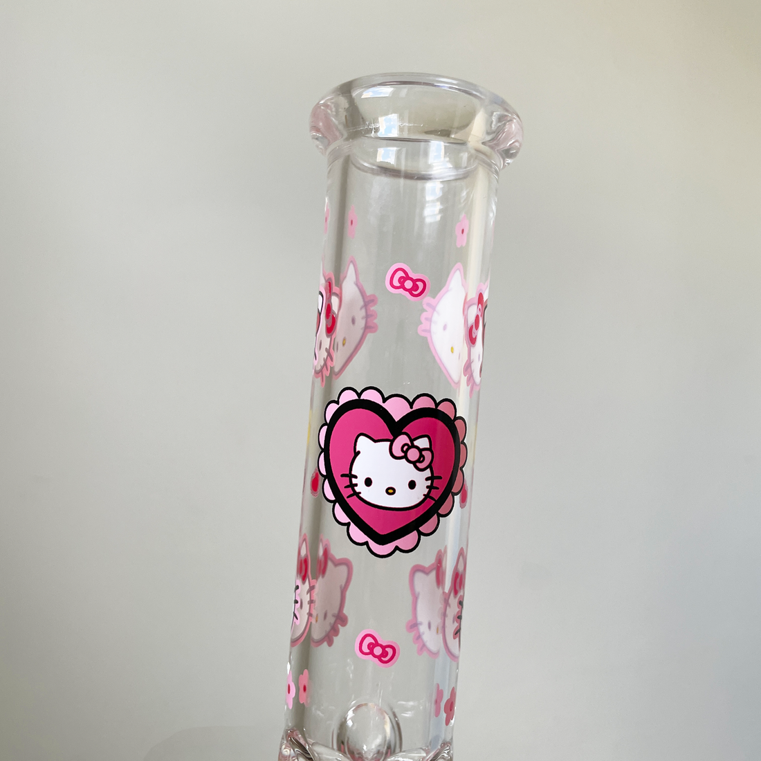 10 inch beaker bong with girly decals of hello kitty and red hearts and pink bows and flowers bliss shop chicago
