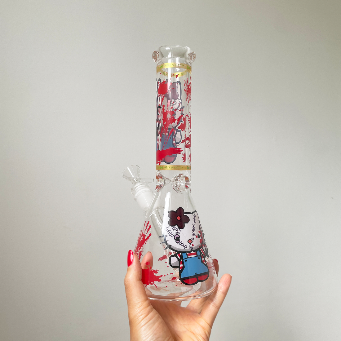 10 inch beaker bong with hello kitty holding a knife and blood splatter design bliss shop chicago