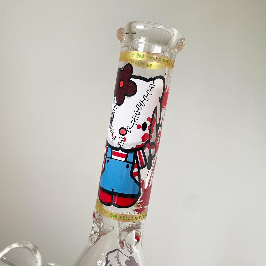 10 inch beaker bong with hello kitty holding a knife and blood splatter design bliss shop chicago