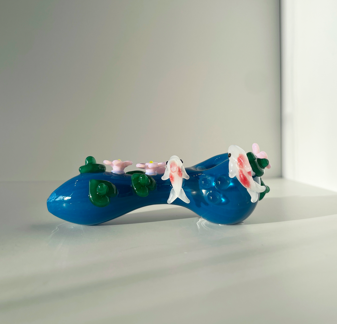 four inch blue spoon pipe with intricate designs of 3d pink flowers, koi fish and leaves bliss shop chicago