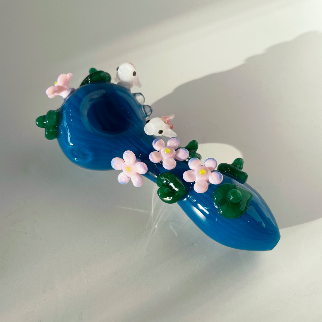 four inch blue spoon pipe with intricate designs of pink flowers, koi fish and leaves bliss shop chicago