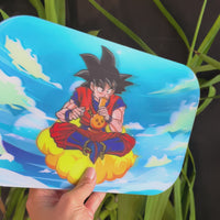 10 by 7 inch metal rolling tray with magnetic lid of hologram image of dragon ball z goku on a cloud smoking a bong bliss shop chicago