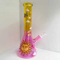 10 inch beaker bong with a bright pink base that transitions to yellow gold at top with large celestial sun, butterflies and cloud decals bliss shop chicago