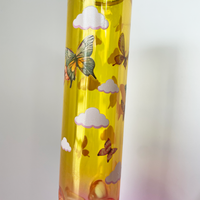  10 inch beaker bong with a bright pink base that transitions to yellow gold at top with large celestial sun, butterflies and cloud decals bliss shop chicago