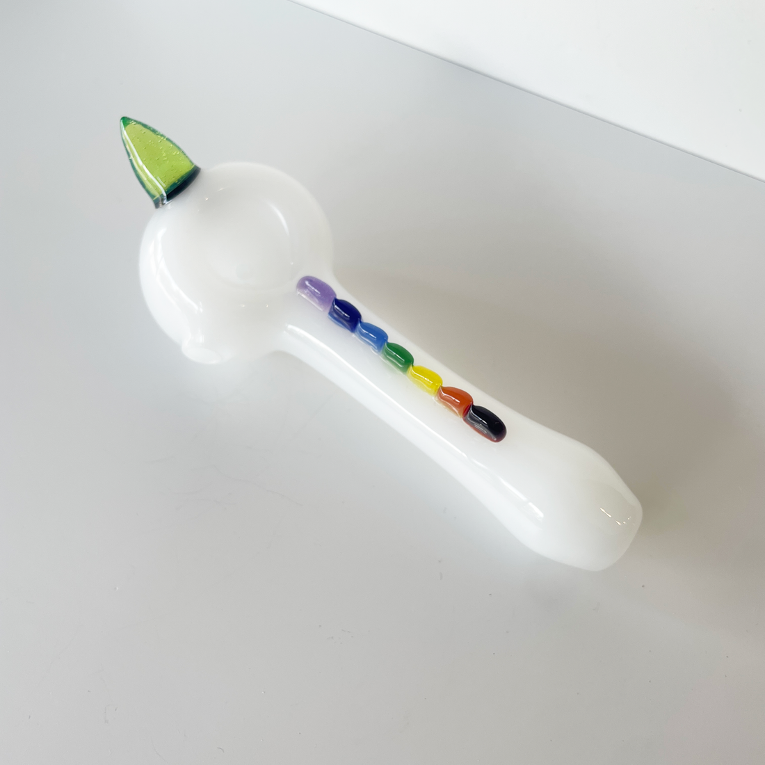 5 inch white spoon pipe by Monster Glass with green unicorn horn and rainbow glass bead design bliss shop chicago
