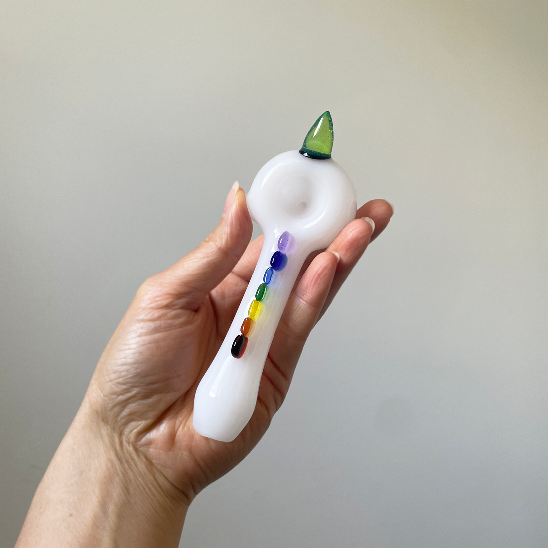 5 inch white spoon pipe by Monster Glass with green unicorn horn and rainbow glass bead design bliss shop chicago